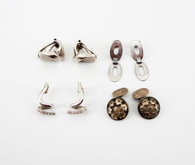 three pairs of silver earrings and a pair of silver ear clips