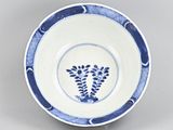 blue and white plate with a flower design on the rim