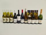many bottles of wine lined up on a table