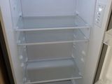 an empty refrigerator with the door open in a kitchen