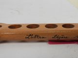 a wooden instrument that has writing on it