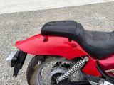 a red motorcycle parked on the side of the road