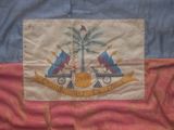 an old flag with the coat of arms of the state of haiti