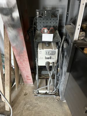 an image of an old gas furnace in a garage
