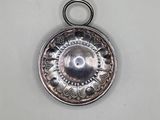 an antique silver plate with a circular design on it