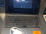 a laptop computer sitting on top of a desk with a charger
