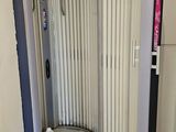 a toilet in the corner of a room with a door open