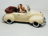 a figurine of a man and woman in a car