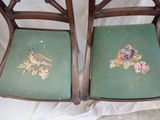 two chairs that have been painted with birds on them