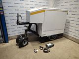 une remorque à laquelle est attelée une autre remorque, dans un garage