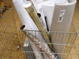 many rolls of paper in a wire basket on the floor