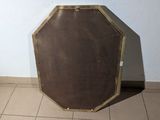 a brown suitcase sitting on a tiled floor in a room