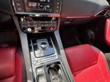 the interior of a car with red leather seats and a center console