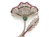 a close up of a brooch with a flower on it