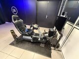 an image of a video game room with a racing simulator