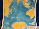 an old map of the ocean is displayed on a table