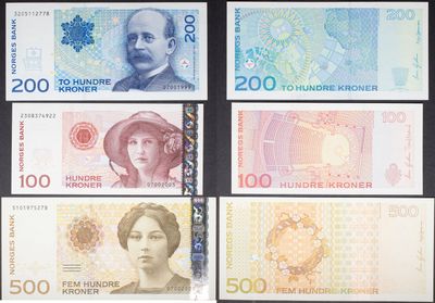 four different bank notes of different colors and shapes on a black background