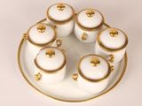 a white plate with gold trim and a white and gold plate with a white and gold plate with a white and gold plate with a white plate and gold