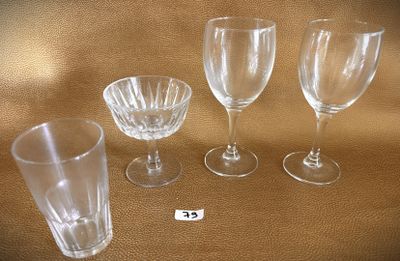 four empty wine glasses sitting on a table next to a price tag
