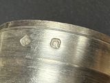 a close up of a silver plate with a diamond on it