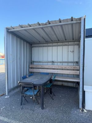 a table and chairs in the back of a shipping container