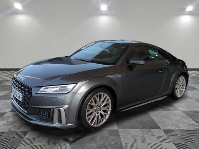 the audi ttr coupe is parked on a checkered tile floor