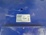 a close up of a blue trash can with a label on it