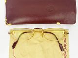 a pair of glasses sitting on top of a cloth next to a pair of glasses