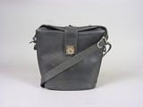 a black leather bag with a metal clasp on the front