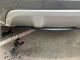 a close up of a car ' s bumper with a small hole in it