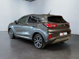 the rear end of a silver car parked in a showroom