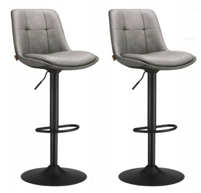 a pair of grey leather bar stools on a white background