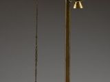 an image of a brass plate with a pendulum and a ball hanging from it
