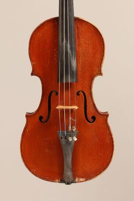 an old violin with a bow hanging from it ' s back