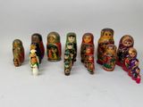 a lot of wooden dolls that are lined up together