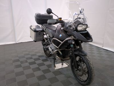 a motorcycle that is parked in a room with a checkered floor