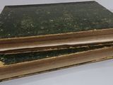 three old books stacked on top of each other on a table