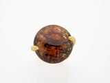 a close up of a ring with a brown stone in it