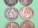 four different types of coins are shown on a green surface