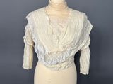 an image of a mannequin torso with a white blouse on it