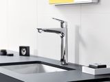 a sink with a faucet and a soap dispenser on it