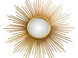 a gold sunburst mirror on a white wall