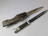 two knives that are sitting next to each other on a table