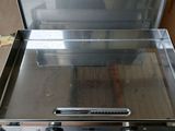 a silver oven that is sitting in a kitchen