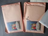 two envelopes with pictures of food on them on a table