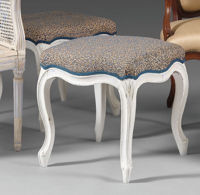 two chairs and a foot stool are sitting next to each other
