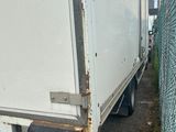 a white truck that is parked next to a chain link fence