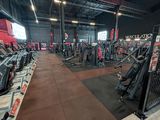 a gym with a lot of exercise equipment in it
