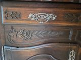 a wooden dresser with a mirror on top of it