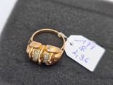 an image of a gold ring with three diamonds on it